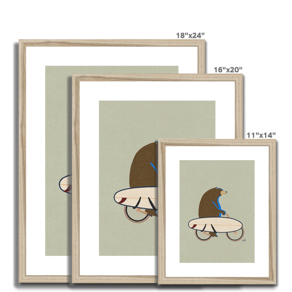 Grizzly riding a bike with a surfboard Framed & Mounted Print