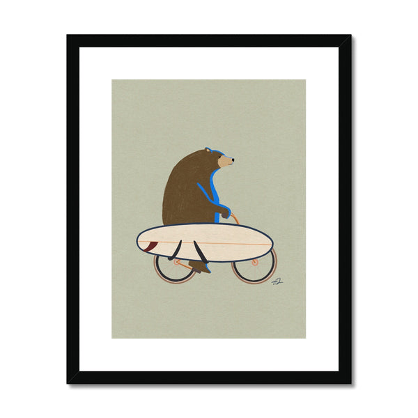 Grizzly riding a bike with a surfboard Framed & Mounted Print